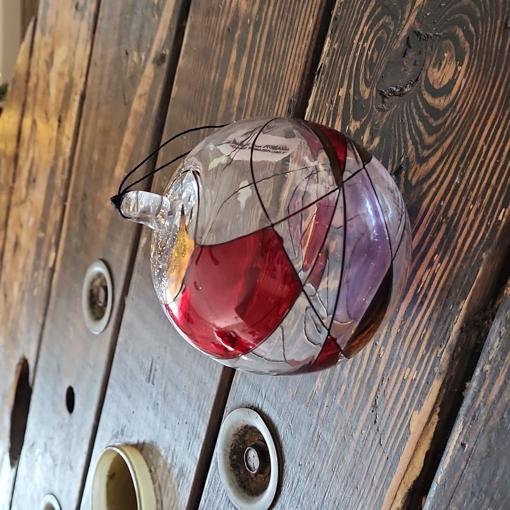 Glass holiday ornament. Appears to be hand blown and handpainted